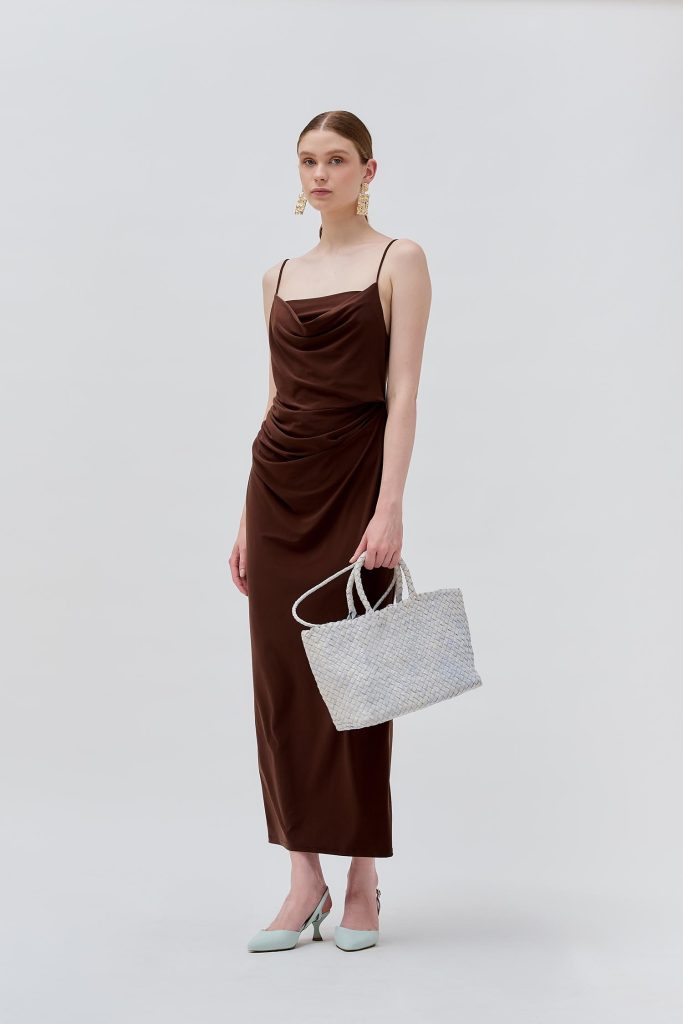 model wearing a light colored middle bag