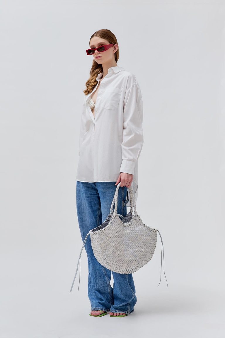 Model wearing a light colored bag